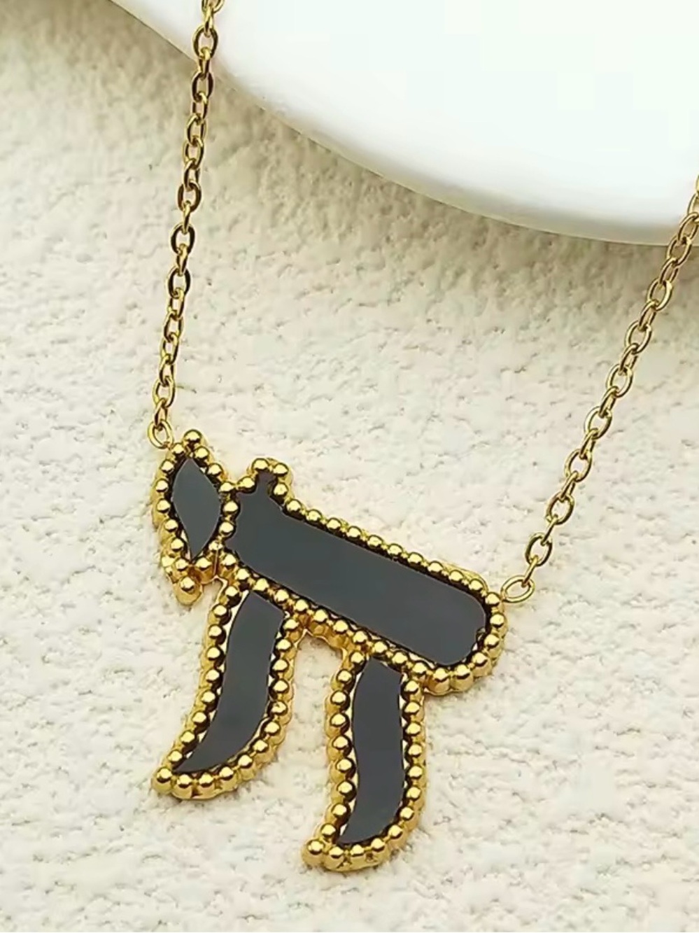 Gold-Tone Hebrew Chai Necklace with Black Enamel Pendant.